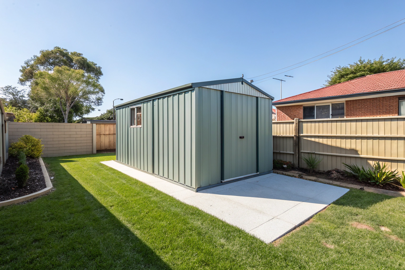 Completed concrete shed slab with shed kit installed Banora Point
